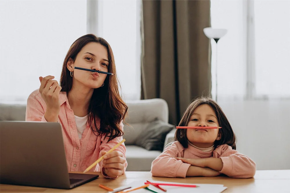 Mother working from home with daughter - SheConnect supportive work environment
